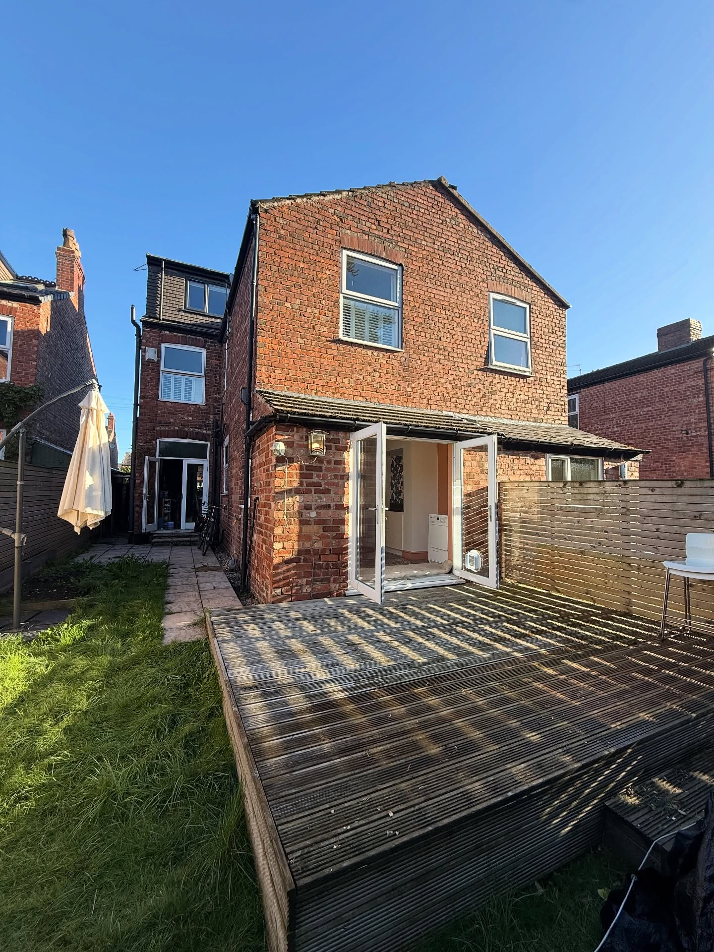 Rear of refurbished house with new timber decking onto garden
