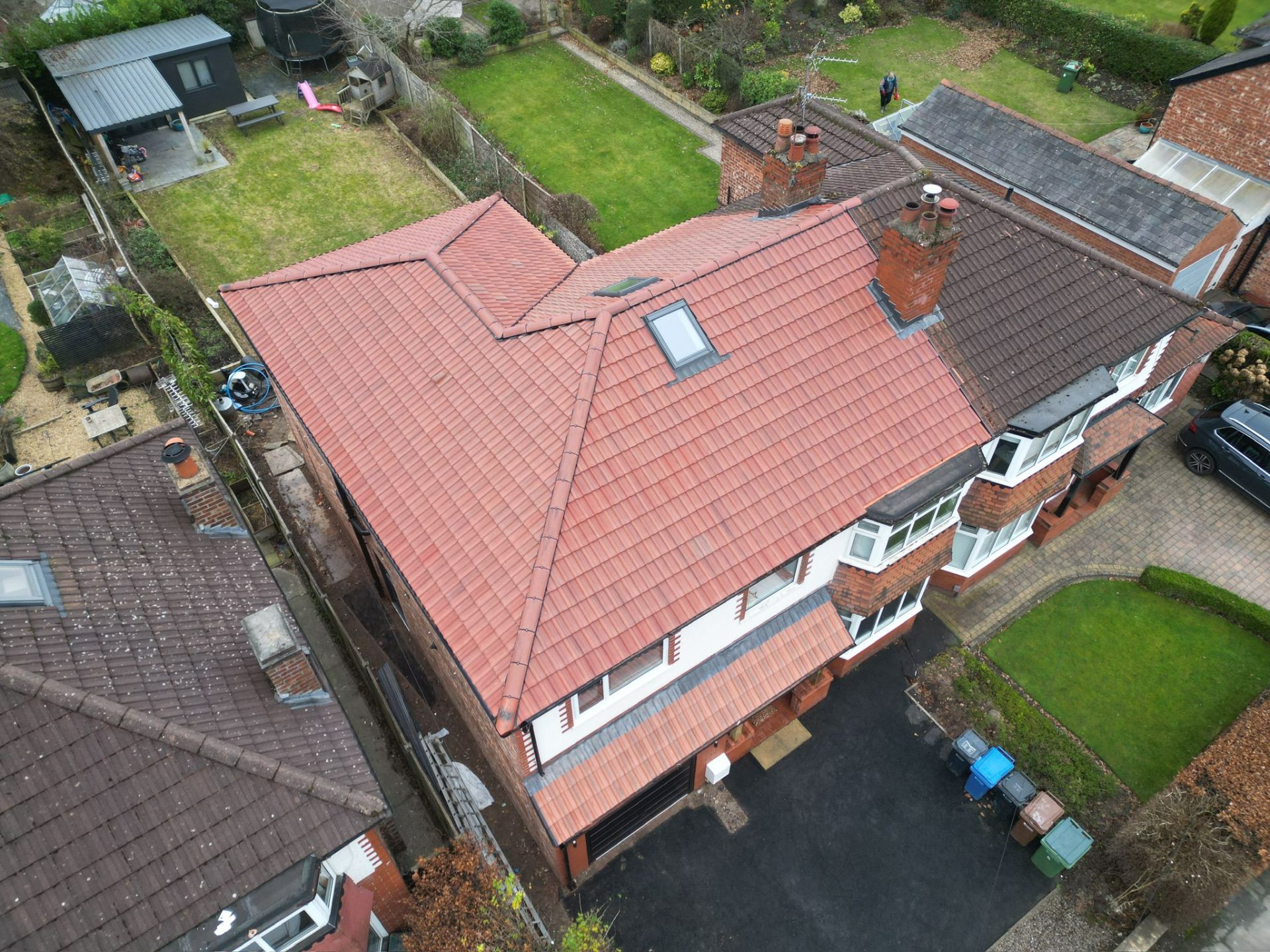 Drone view of a completed full roof re-tile with new chimney flashings and rooflight