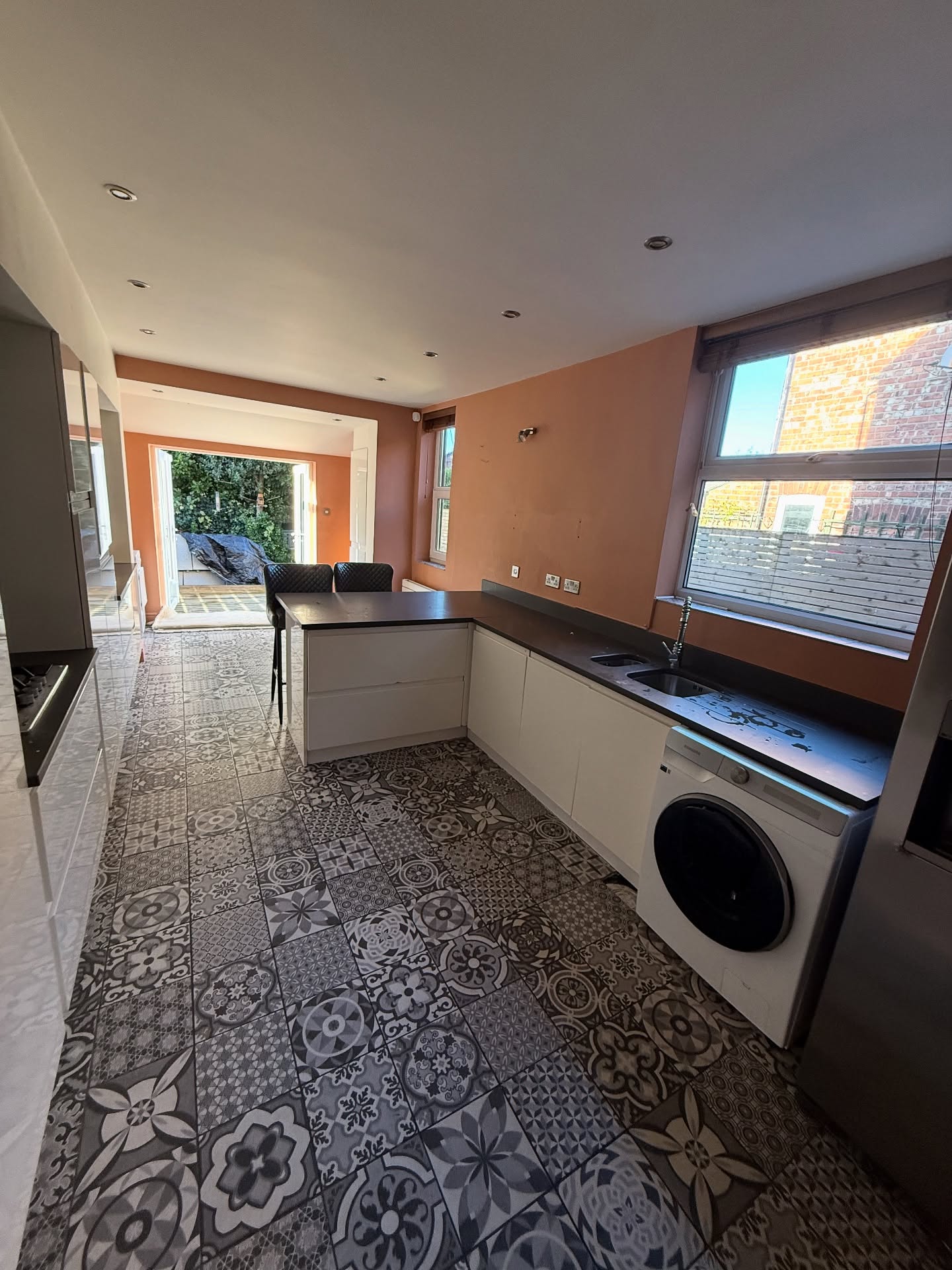 Refurbished kitchen with patterned tile flooring