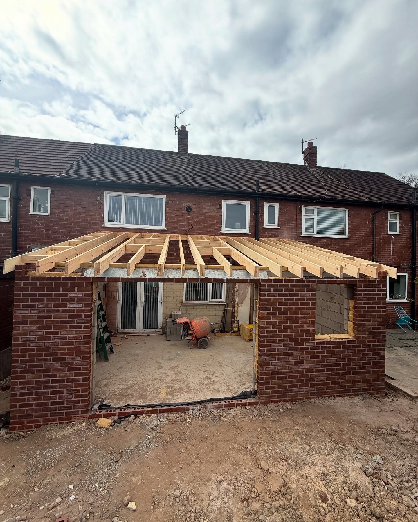 Brickwork shell of a rear extension with timber roof structure